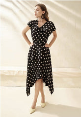 Silk polka dot dress with cowl neckline and asymmetrical hem for a playful feminine look